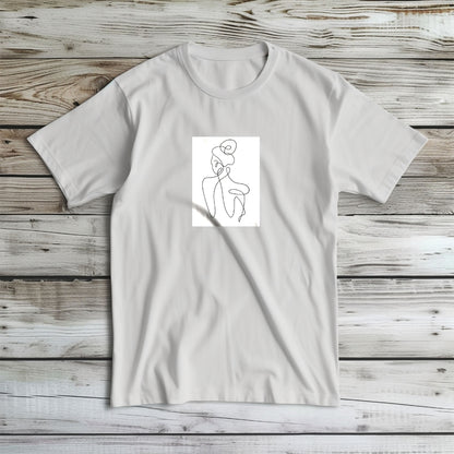 Koszulka Kiskedves Line Art rozłożona, z postacią od tyłu, na jasnym drewnie.